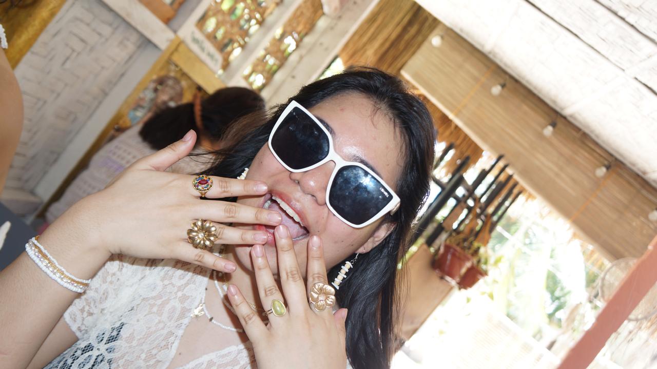 Thressia making a goofy face in big white sunglasses